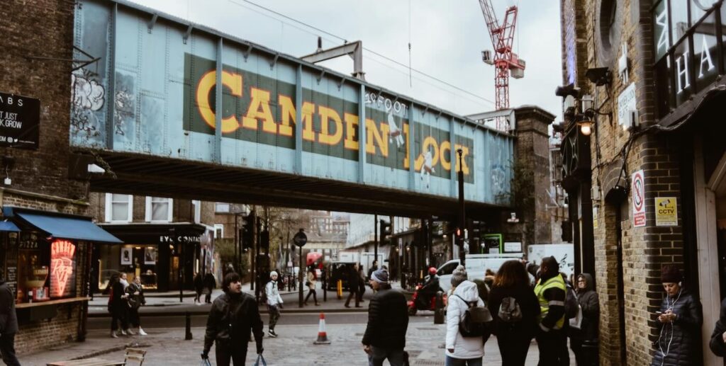 Vibrant Camden Market street with colourful signs and Victorian architecture in London