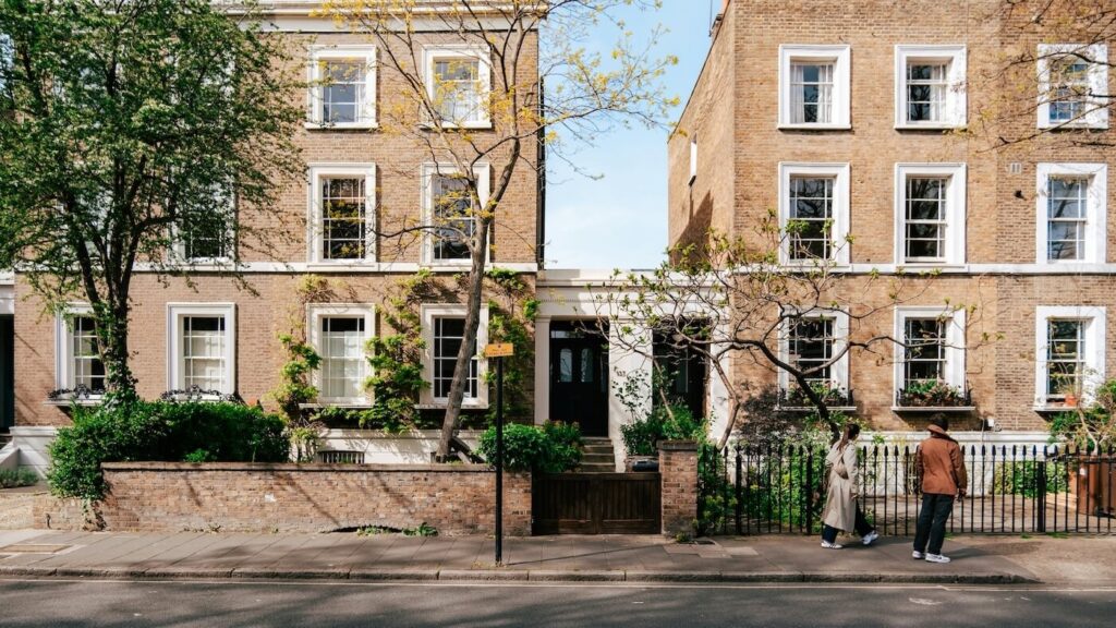 Georgian terraced houses with mature trees on a residential street in Islington, London